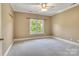 Neutral bedroom with plenty of natural light from a sunny window and ceiling fan at 18618 Rollingdale Ln, Davidson, NC 28036