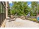A spacious wooden deck features outdoor seating and a hot tub, perfect for entertaining and enjoying the wooded view at 18618 Rollingdale Ln, Davidson, NC 28036