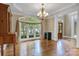 Spacious dining room with hardwood floors, large windows, and classic chandelier lighting fixture at 18618 Rollingdale Ln, Davidson, NC 28036