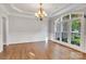 Elegant dining room featuring a large window, wainscoting detail, and a stylish chandelier at 18618 Rollingdale Ln, Davidson, NC 28036