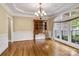 Traditional dining room featuring a wooden hutch, hardwood floors, and a large window with decorative curtains at 18618 Rollingdale Ln, Davidson, NC 28036