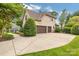 Charming two-story brick home with an attached three-car garage and mature landscaping at 18618 Rollingdale Ln, Davidson, NC 28036
