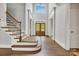 Grand foyer with a staircase, soaring ceilings, wood floors, and large windows providing natural light at 18618 Rollingdale Ln, Davidson, NC 28036