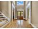 Spacious foyer with hardwood floors, a staircase, and a view of the double front doors and transom window at 18618 Rollingdale Ln, Davidson, NC 28036
