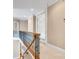 Bright upstairs hallway with white trim and iron railing overlooking foyer below at 18618 Rollingdale Ln, Davidson, NC 28036