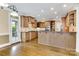 Spacious kitchen featuring custom cabinetry, stainless steel appliances, hardwood floors, and a large island at 18618 Rollingdale Ln, Davidson, NC 28036