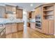 Stylish kitchen with light wood cabinets, stainless steel appliances, and ample countertop space for cooking at 18618 Rollingdale Ln, Davidson, NC 28036