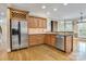 Well-equipped kitchen with stainless steel appliances, custom cabinetry, hardwood floors, and bar seating at 18618 Rollingdale Ln, Davidson, NC 28036