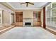 Inviting living room with stone fireplace, built-in bookshelves, and plush carpet at 18618 Rollingdale Ln, Davidson, NC 28036