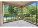 Inviting screened porch offering beautiful views of the private backyard and pool at 18618 Rollingdale Ln, Davidson, NC 28036