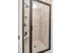 Modern shower with tiled walls, a glass door, and a built-in shower caddy at 18618 Rollingdale Ln, Davidson, NC 28036