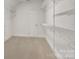 Well-organized walk-in closet with ample shelving and carpet flooring at 18618 Rollingdale Ln, Davidson, NC 28036