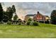 Expansive backyard with an iron fence, lush landscaping, and a charming covered patio at 1901 Benjamin Dr, Salisbury, NC 28146