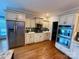 Open kitchen featuring stainless steel appliances, granite countertops, and light wood floor at 1901 Benjamin Dr, Salisbury, NC 28146