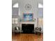 Elegant living room with fireplace, stylish chairs, hardwood floors, and ample natural light at 1901 Benjamin Dr, Salisbury, NC 28146