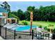 Luxurious backyard pool area with a gazebo, fire pit, and lush landscaping for outdoor entertaining at 1901 Benjamin Dr, Salisbury, NC 28146