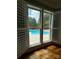 Inviting view of a sparkling in-ground pool and landscaped backyard seen from a window with white shutters at 1901 Benjamin Dr, Salisbury, NC 28146
