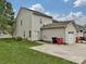 View of the home's rear exterior with a lawn, garage and driveway at 20025 Metaphor Mews None, Davidson, NC 28036