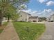 Side view of the house, featuring a well-maintained lawn and attached garage at 20025 Metaphor Mews None, Davidson, NC 28036