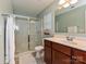 Bathroom features a glass-enclosed shower, vanity with sink, and a window for natural light at 20025 Metaphor Mews None, Davidson, NC 28036