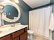 Bathroom boasts a round mirror, modern lighting, and shower with decorative curtains at 20025 Metaphor Mews None, Davidson, NC 28036