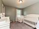 Cozy Bedroom with a white crib and soft chair, perfect for a growing Gathering at 20025 Metaphor Mews None, Davidson, NC 28036