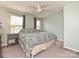 Cozy bedroom featuring a ceiling fan, two windows, and neutral decor at 20025 Metaphor Mews None, Davidson, NC 28036