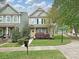 Charming two-story home with a yellow door, manicured lawn and welcoming curb appeal at 20025 Metaphor Mews None, Davidson, NC 28036