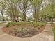 Community landscaping featuring trees, mulched flowerbeds, and sidewalks at 20025 Metaphor Mews None, Davidson, NC 28036