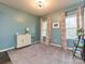 Bright living room with neutral paint, large windows with valances, and light-colored carpeting at 20025 Metaphor Mews None, Davidson, NC 28036