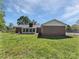Back exterior of a brick home with a sunroom and a spacious green yard at 2035 Mauney Rd, Bessemer City, NC 28016