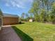 Expansive backyard featuring lush greenery, a storage shed, and ample space for outdoor activities and relaxation at 2035 Mauney Rd, Bessemer City, NC 28016