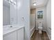 Clean bathroom featuring a vanity with storage, a toilet, and tiled shower at 2035 Mauney Rd, Bessemer City, NC 28016