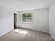 Cozy bedroom filled with natural light and plush carpeting offers a serene and comfortable retreat at 2035 Mauney Rd, Bessemer City, NC 28016