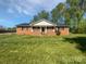 Charming brick home featuring a welcoming front porch and a spacious lawn at 2035 Mauney Rd, Bessemer City, NC 28016