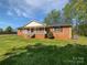 Charming brick home featuring a welcoming front porch and a spacious lawn at 2035 Mauney Rd, Bessemer City, NC 28016