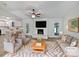 Bright living room with fireplace, plush seating, and open concept to kitchen at 2035 Mauney Rd, Bessemer City, NC 28016