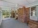 Bright sunroom featuring brick accents and lots of natural light, ideal for relaxing or entertaining guests at 2035 Mauney Rd, Bessemer City, NC 28016