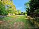 Wide shot of a large backyard with a wooden fence in a suburban area at 213 Meadow Wind Ct, Monroe, NC 28110