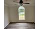 Bedroom featuring a ceiling fan and arched window providing lots of natural light and plank floors at 213 Meadow Wind Ct, Monroe, NC 28110