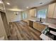 Bright, updated kitchen with new flooring, stainless steel appliances, and adjacent dining area at 213 Meadow Wind Ct, Monroe, NC 28110