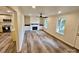 Spacious living room with hardwood floors, built in fireplace, and lots of natural light at 213 Meadow Wind Ct, Monroe, NC 28110