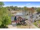 Aerial view of a brick home on a landscaped lot, backing to the lake with a private dock at 220 Chandeleur Dr, Mooresville, NC 28117