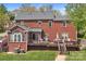 Large brick home with a spacious deck and outdoor entertaining area at 220 Chandeleur Dr, Mooresville, NC 28117