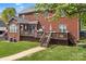 Spacious backyard featuring a beautiful deck, manicured lawn, and brick exterior at 220 Chandeleur Dr, Mooresville, NC 28117