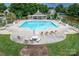 Aerial view of community pool with ample lounge chairs surrounded by lush landscaping and manicured lawns at 220 Chandeleur Dr, Mooresville, NC 28117