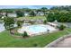 Inviting community pool surrounded by lush greenery with a lake view and lounge area at 220 Chandeleur Dr, Mooresville, NC 28117