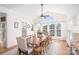 Sunlit dining room with a large table, wood floors, and expansive windows at 220 Chandeleur Dr, Mooresville, NC 28117