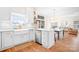Charming kitchen with white cabinetry, stainless steel appliances, and an adjacent dining area at 220 Chandeleur Dr, Mooresville, NC 28117