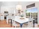 Bright eat-in kitchen features white cabinetry, stainless steel appliances, and sliding doors to the backyard at 220 Chandeleur Dr, Mooresville, NC 28117